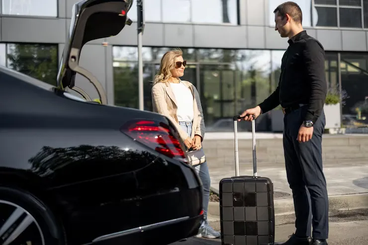 chauffeur-packs-suitcase-car-trunk-businesswoman-waiting-nearby-using-luxury-taxi-service-business-trip-concept-business-transfer-services-idea-personal-driver